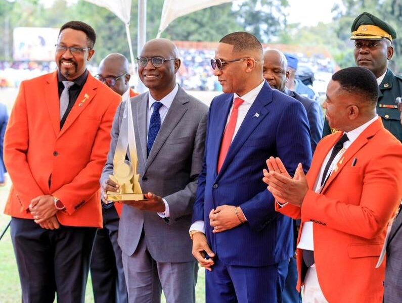 Econet Deputy CEO Roy Chimanikire (second from left) smiles as he receives the ZITF Supreme Stand Award 2026 from President Duma Boko (centre). Looking on is the Board Chairman of the ZITF company, Mr Busisa Moyo (left) and the CEO of the ZITF company Dr Nicholas Ndebele (right).